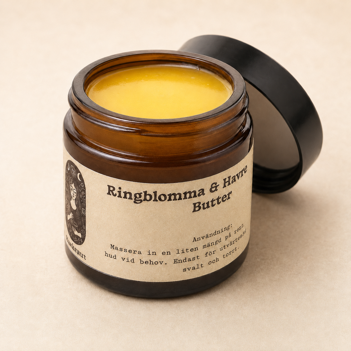 An open amber glass jar of calendula & oat lotion butter with a black lid resting behind it on a light beige background. The label is cream-colored with black text and features a vintage-style portrait illustration.